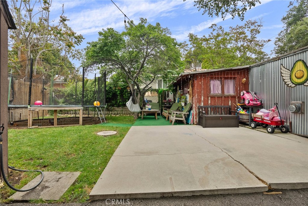 7553 McGroarty Street Tujunga, CA 91042 - Photo 21 of 26 a view of a chair and tables in the back yard of a house