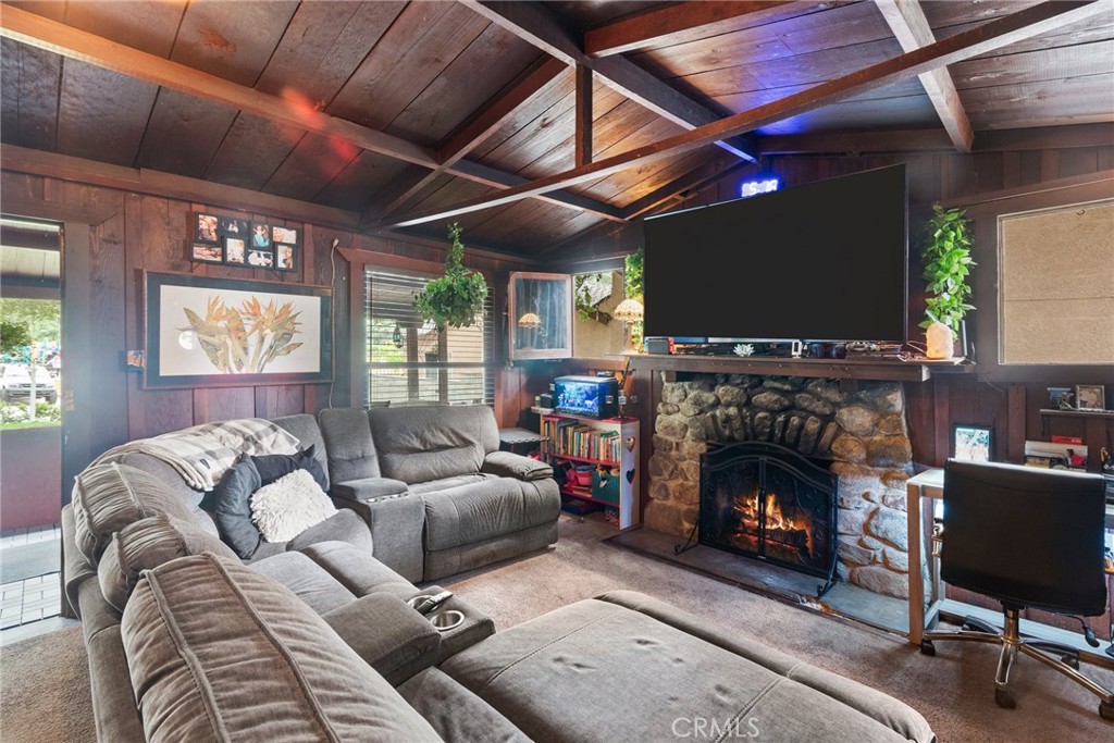 7553 McGroarty Street Tujunga, CA 91042 - Photo 10 of 26 a living room with furniture a fireplace and a flat screen tv