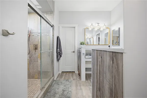 a view of a bathroom with a sink and a mirror