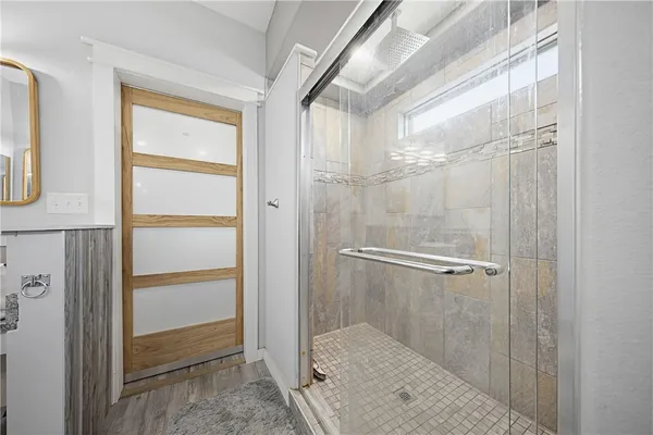 a bathroom with a glass shower door