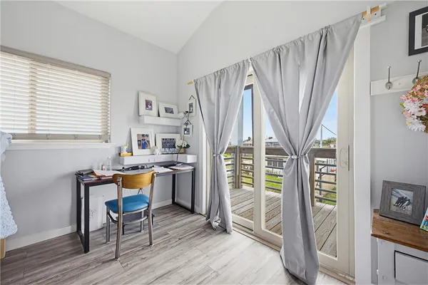 a dining room with wooden floor and a window