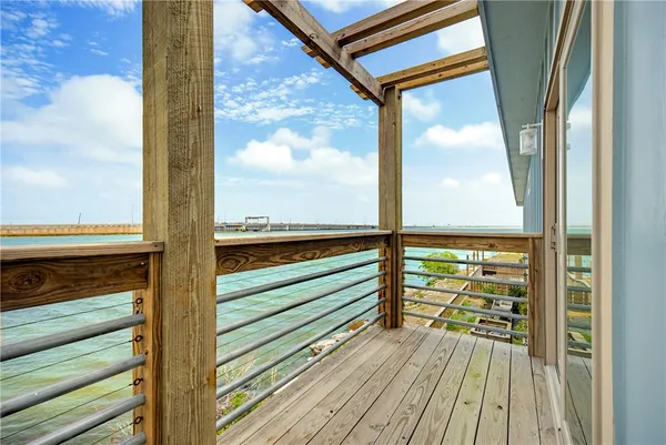 a view of a balcony with floor to ceiling windows with wooden floor