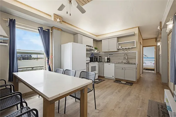 a kitchen with refrigerator cabinets and wooden floor