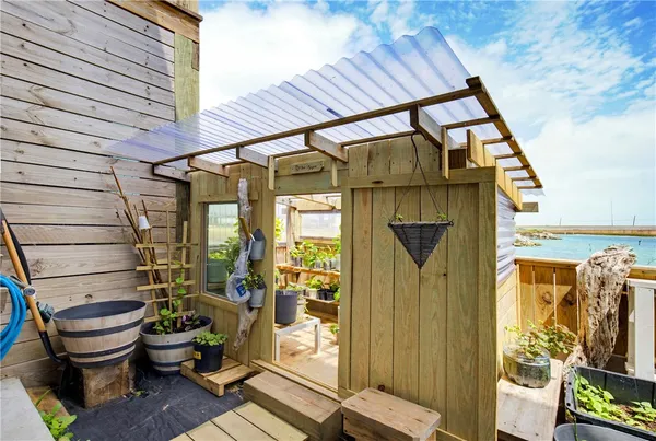 a view of a house with wooden fence