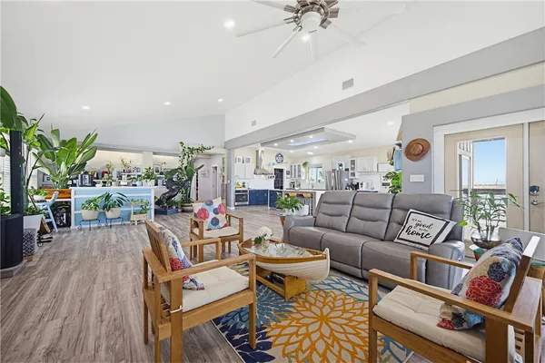 a living room with furniture and wooden floor