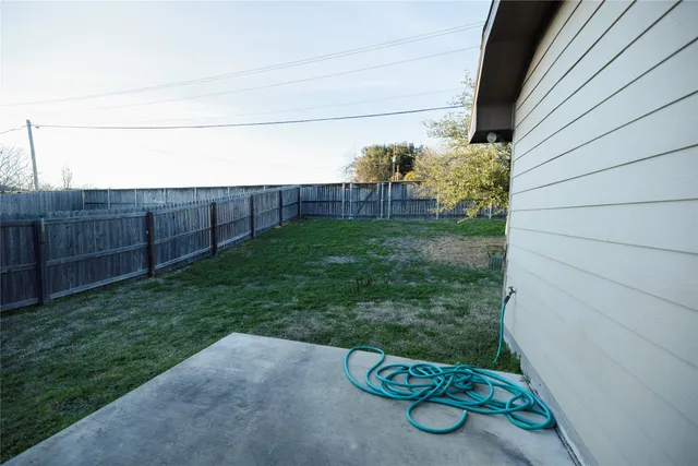 a view of backyard with tub and trees