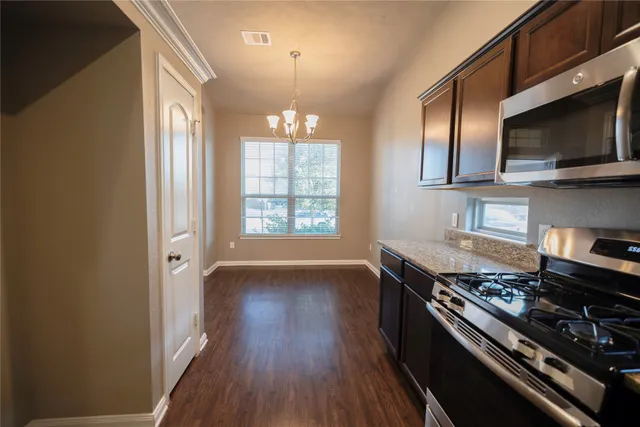 a kitchen with stainless steel appliances a stove and a microwave