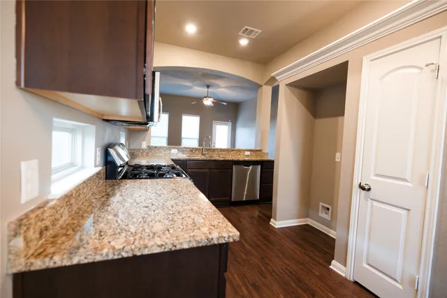a large kitchen with a stove a sink and a refrigerator