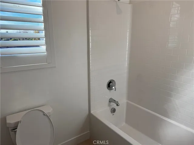 a bathroom with a bathtub and toilet