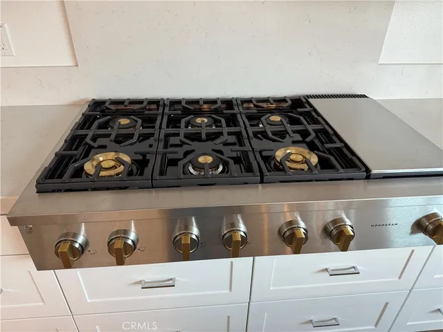 a bathroom with a stove and a cabinets