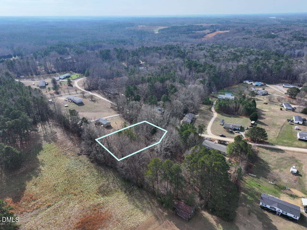55 Spring Lane Henderson, NC 27537 - Photo 3 of 17 an aerial view of house with yard and mountain view in back