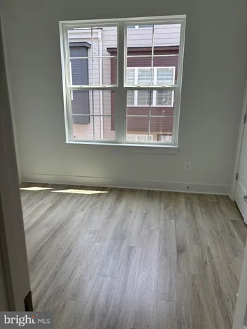 a view of a room with wooden floor and windows
