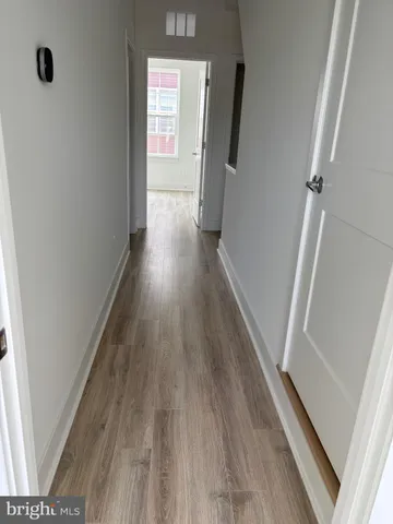 a view of hallway with wooden floor