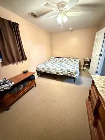 a bedroom with bed and window