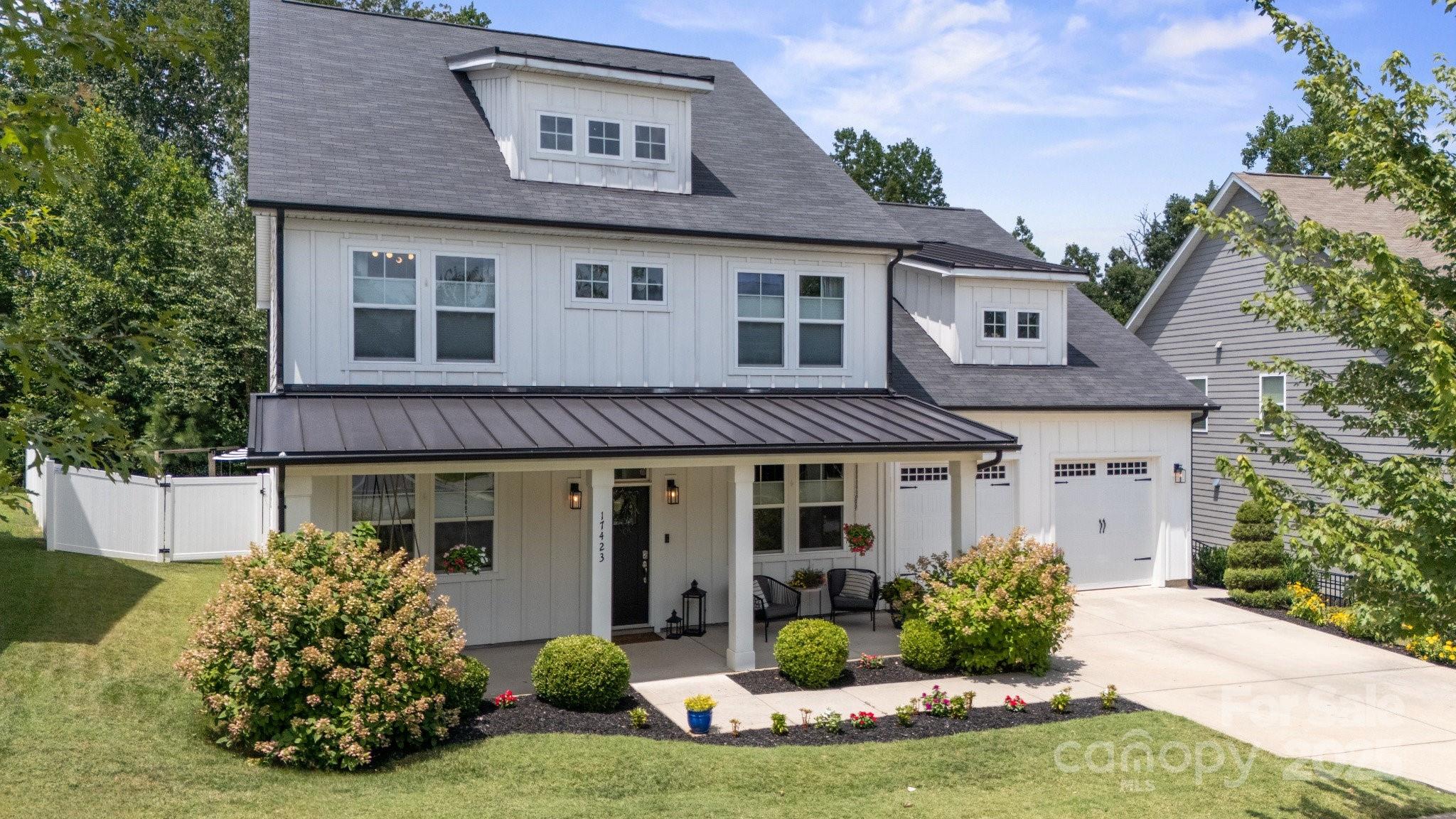 17423 Summers Walk Boulevard Davidson, NC 28036 - Photo 1 of 40 a front view of a house with a yard and potted plants