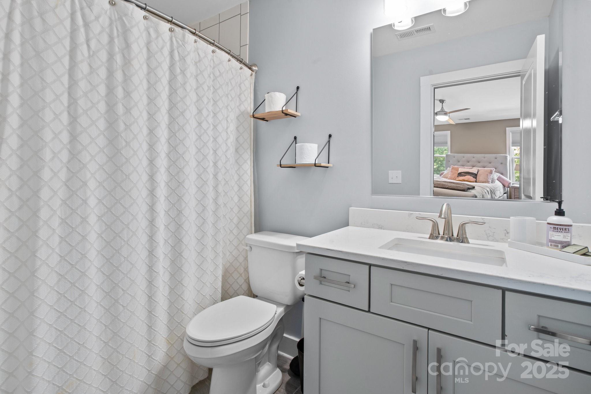 17423 Summers Walk Boulevard Davidson, NC 28036 - Photo 26 of 40 a bathroom with a granite countertop sink and a toilet