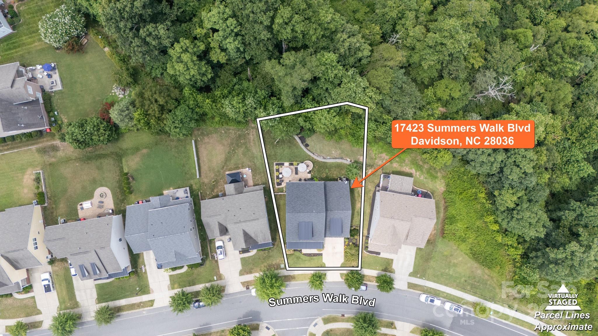 17423 Summers Walk Boulevard Davidson, NC 28036 - Photo 35 of 40 an outdoor sitting area with a table and chairs