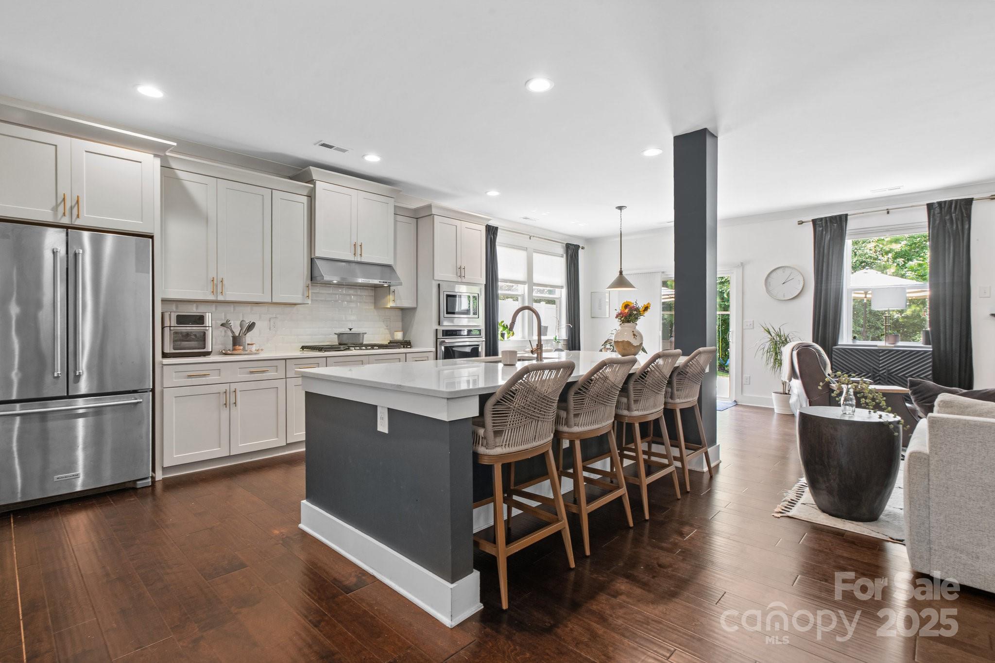 17423 Summers Walk Boulevard Davidson, NC 28036 - Photo 10 of 40 a kitchen with stainless steel appliances a stove a sink a refrigerator dining table and chairs