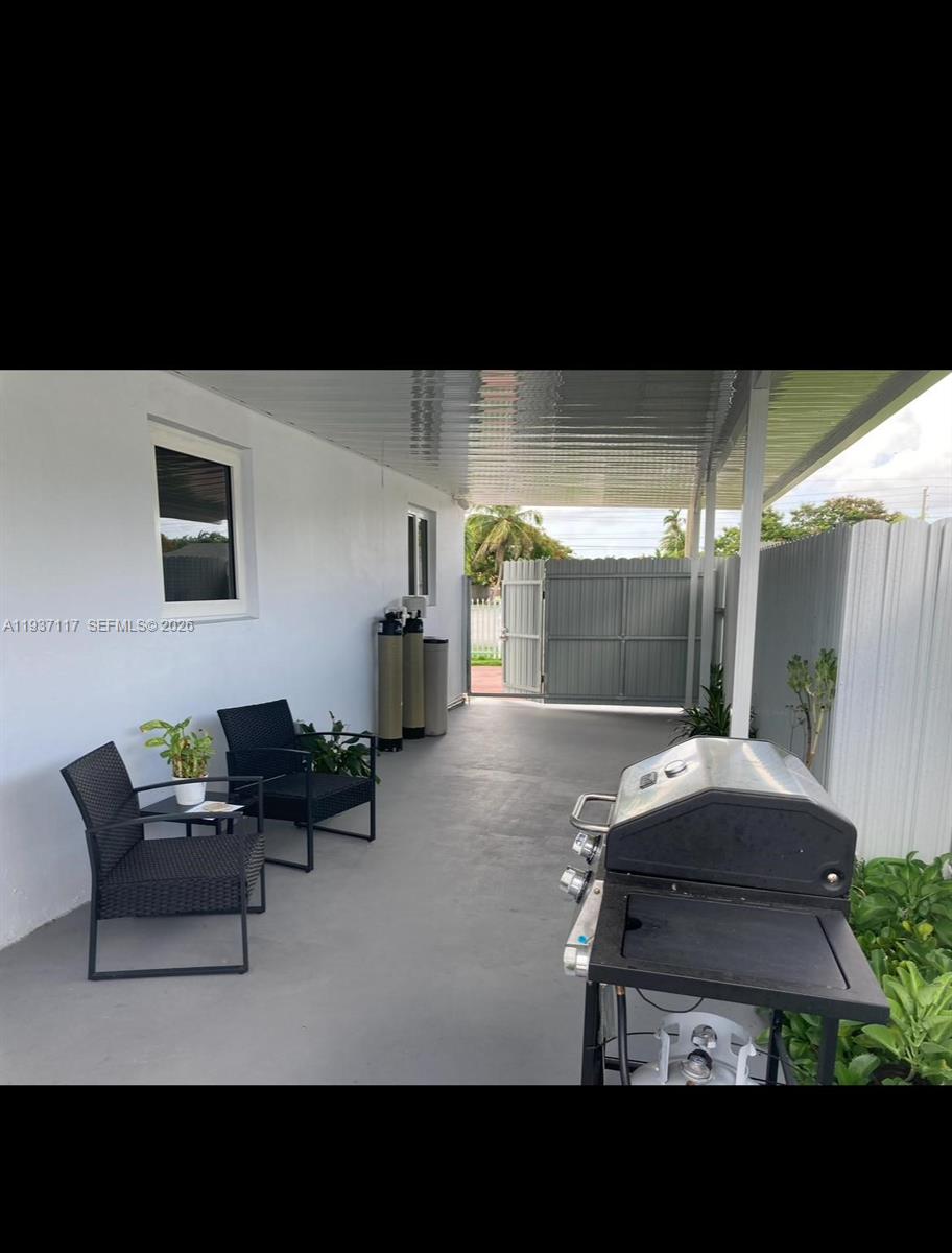 11860 Southwest 35th Street, Unit 1 Miami, FL 33175 - Photo 2 of 7 a living room with furniture and a glass door