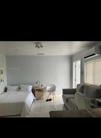 a view of a bedroom with furniture