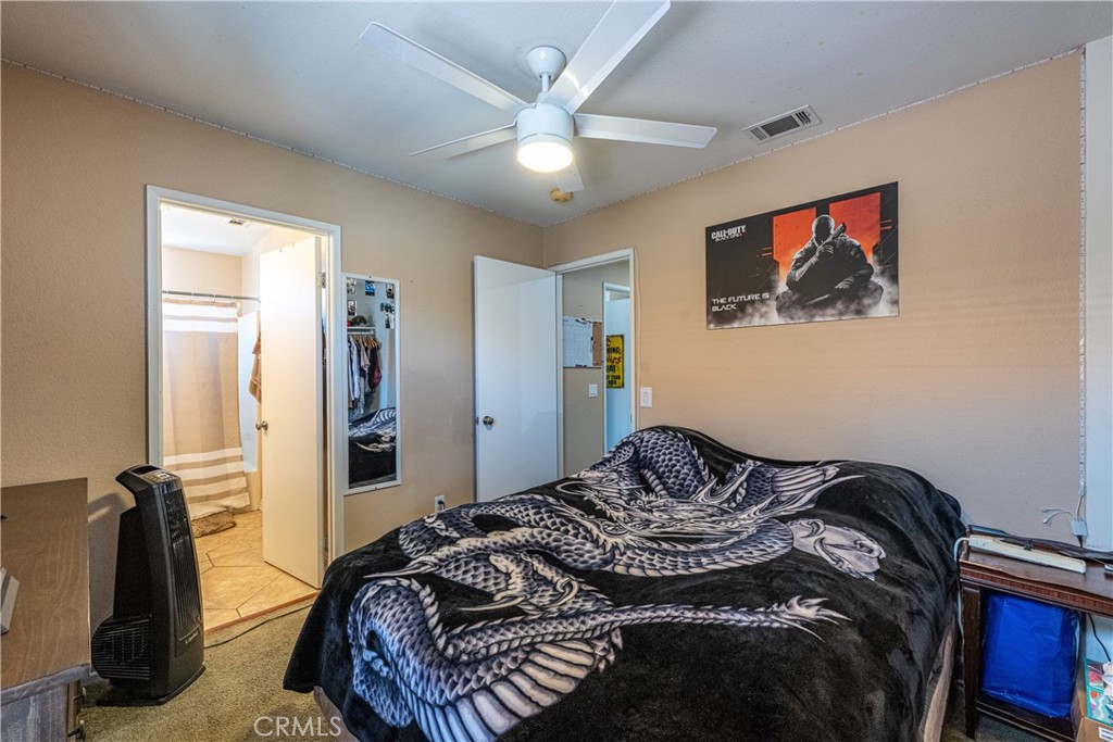 651 Viewpointe Lane Corona, CA 92881 - Photo 17 of 28 a bedroom with a bed and a chandelier