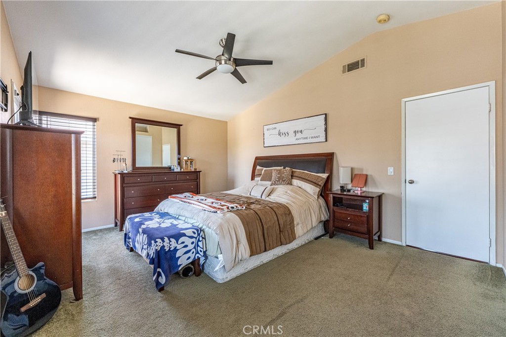 651 Viewpointe Lane Corona, CA 92881 - Photo 20 of 28 a bedroom with a bed and a chandelier