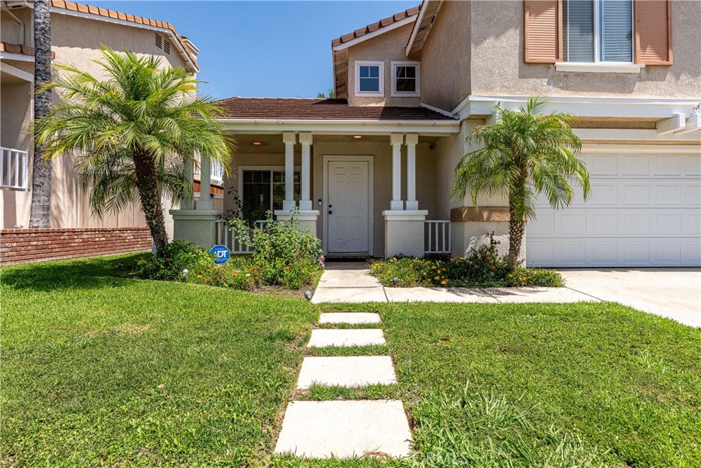 651 Viewpointe Lane Corona, CA 92881 - Photo 2 of 28 a front view of a house with a yard and potted plants