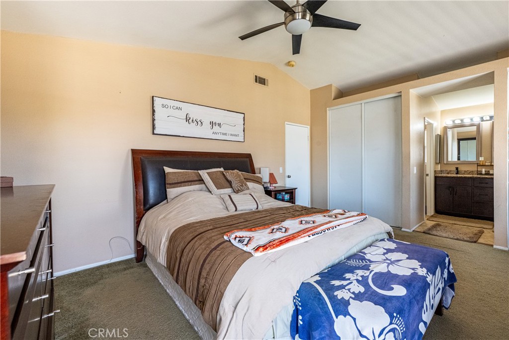 651 Viewpointe Lane Corona, CA 92881 - Photo 21 of 28 a bedroom with a bed and a chandelier