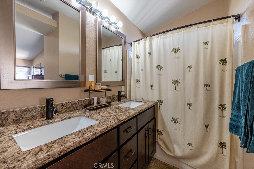 651 Viewpointe Lane Corona, CA 92881 - Photo 23 of 28 a bathroom with a granite countertop double vanity sink and mirror