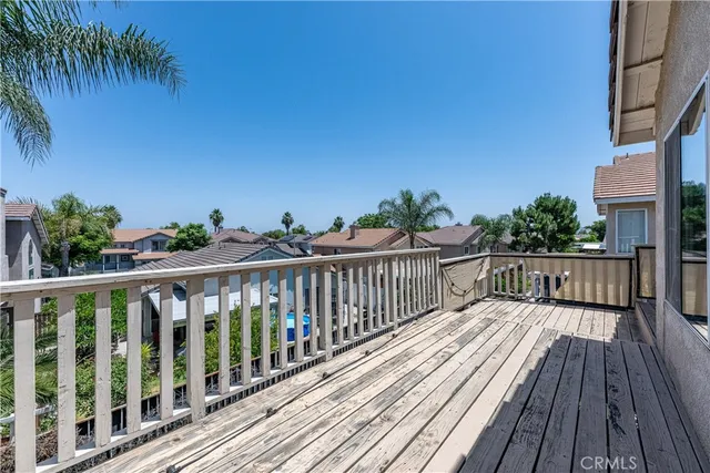 a view of balcony with wooden floor and fence