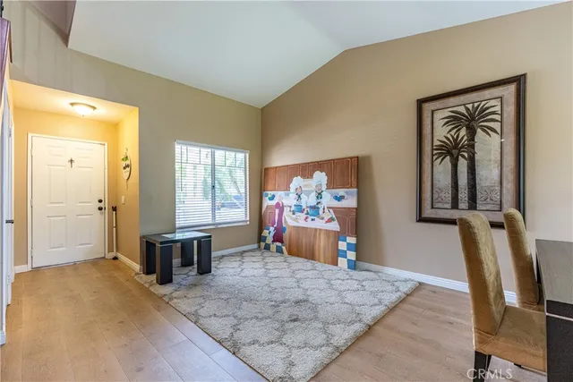 a view of a livingroom with wooden floor and furniture