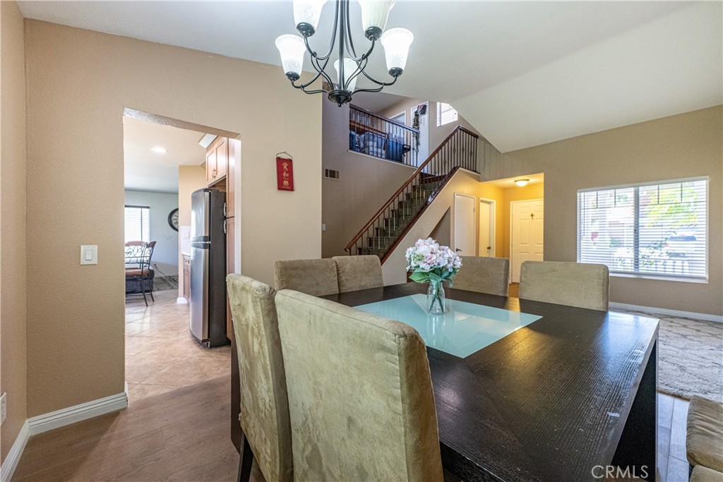 651 Viewpointe Lane Corona, CA 92881 - Photo 7 of 28 a view of a livingroom and dining room with furniture wooden floor a chandelier