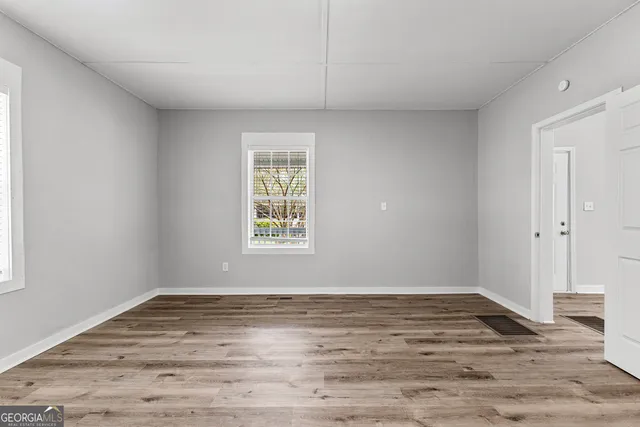 a view of wooden floor and windows in a room