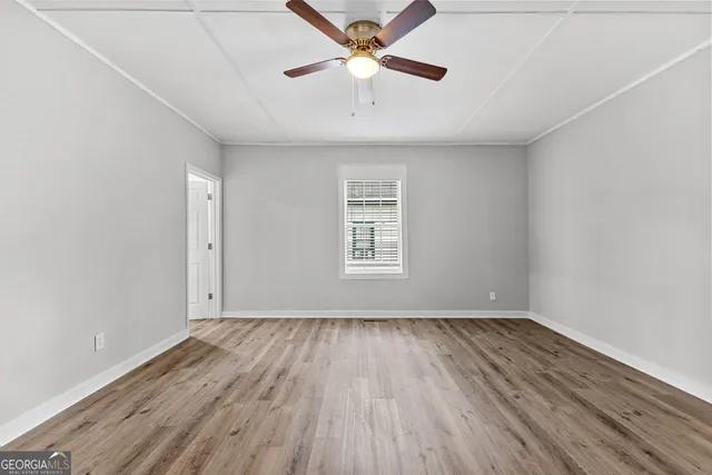wooden floor in an empty room with a window