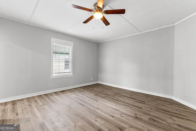 wooden floor in an empty room with a window