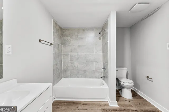 a bathroom with a bathtub and a toilet