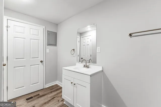 a bathroom with a sink a vanity and a mirror