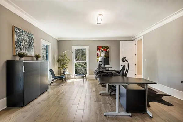 a kitchen with stainless steel appliances kitchen island granite countertop a table chairs and a refrigerator