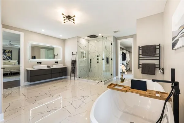 a bathroom with a bathtub a sink and a shower