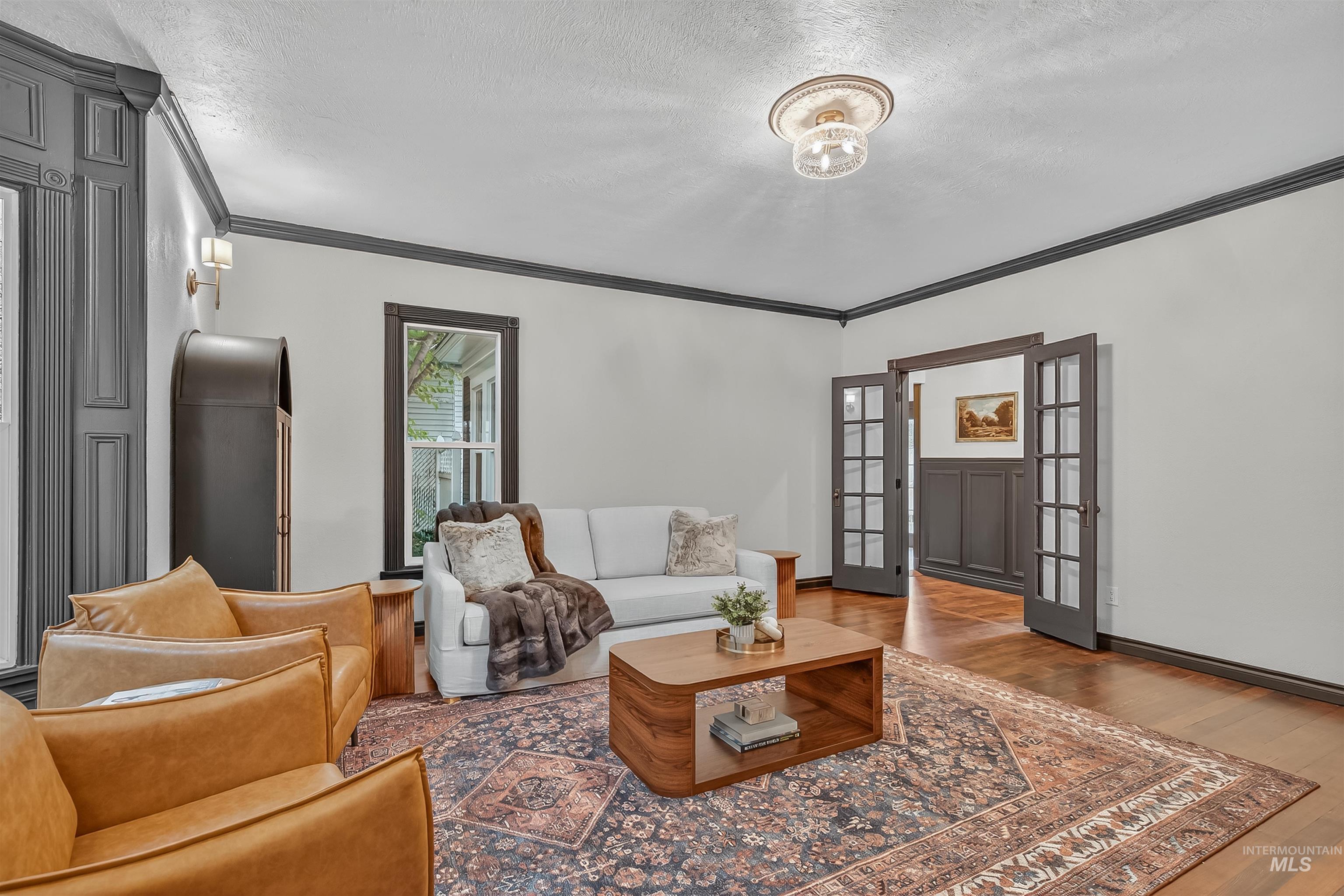 302 7th Avenue Lewiston, ID 83501 - Photo 2 of 50 Living area featuring crown molding, a textured ceiling, and wood finished floors