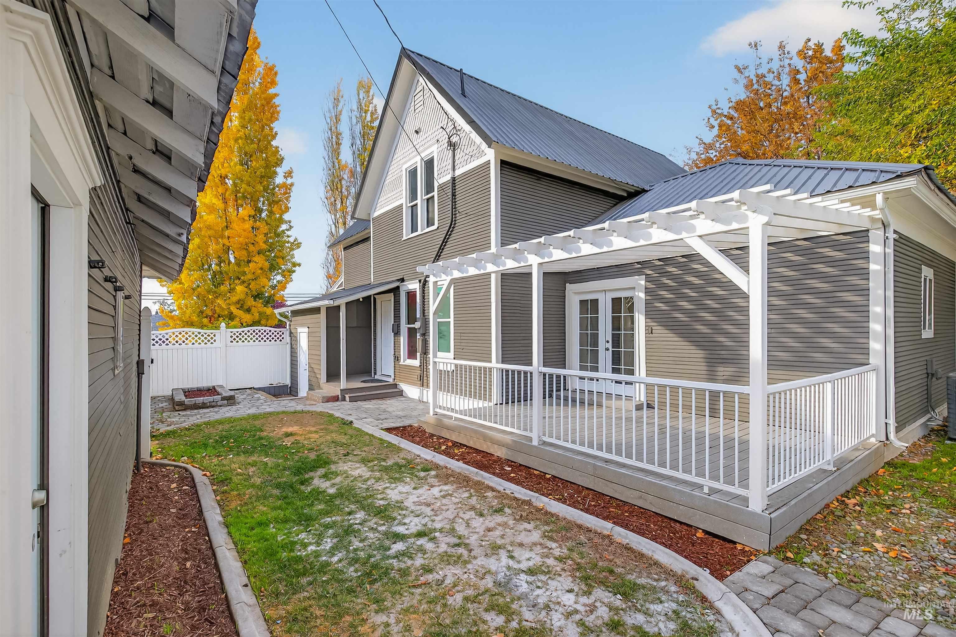 302 7th Avenue Lewiston, ID 83501 - Photo 32 of 50 Back of house with a metal roof, a deck, and a pergola