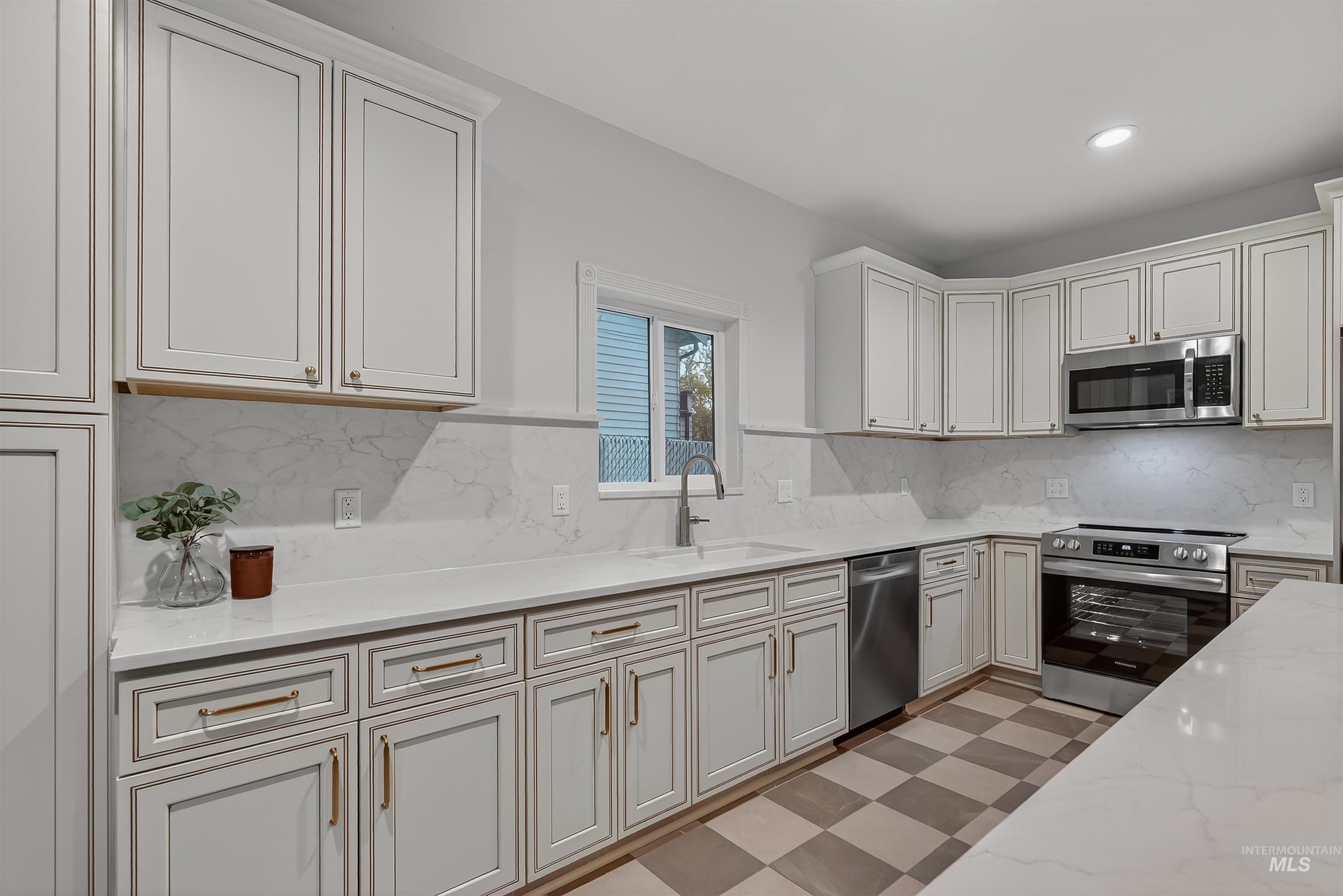 302 7th Avenue Lewiston, ID 83501 - Photo 9 of 50 Kitchen with stainless steel appliances, light stone counters, backsplash, light floors, and recessed lighting
