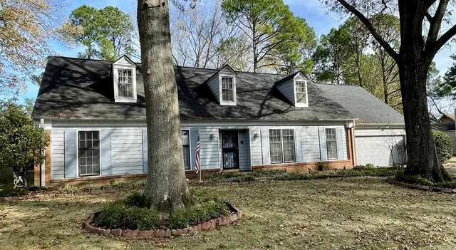 a front view of a house with garden