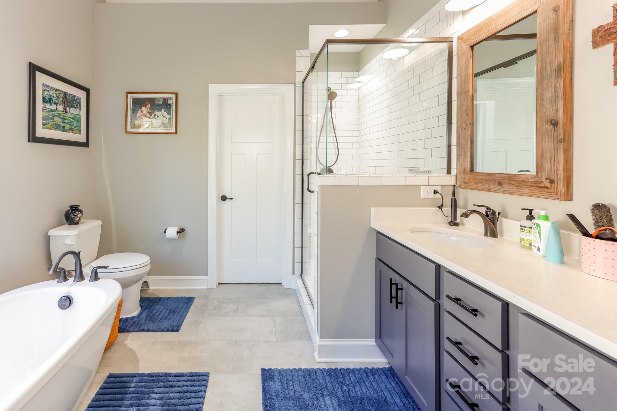 174 Spring Street Spindale, NC 28160 - Photo 12 of 30 a spacious bathroom with a tub sink and mirror
