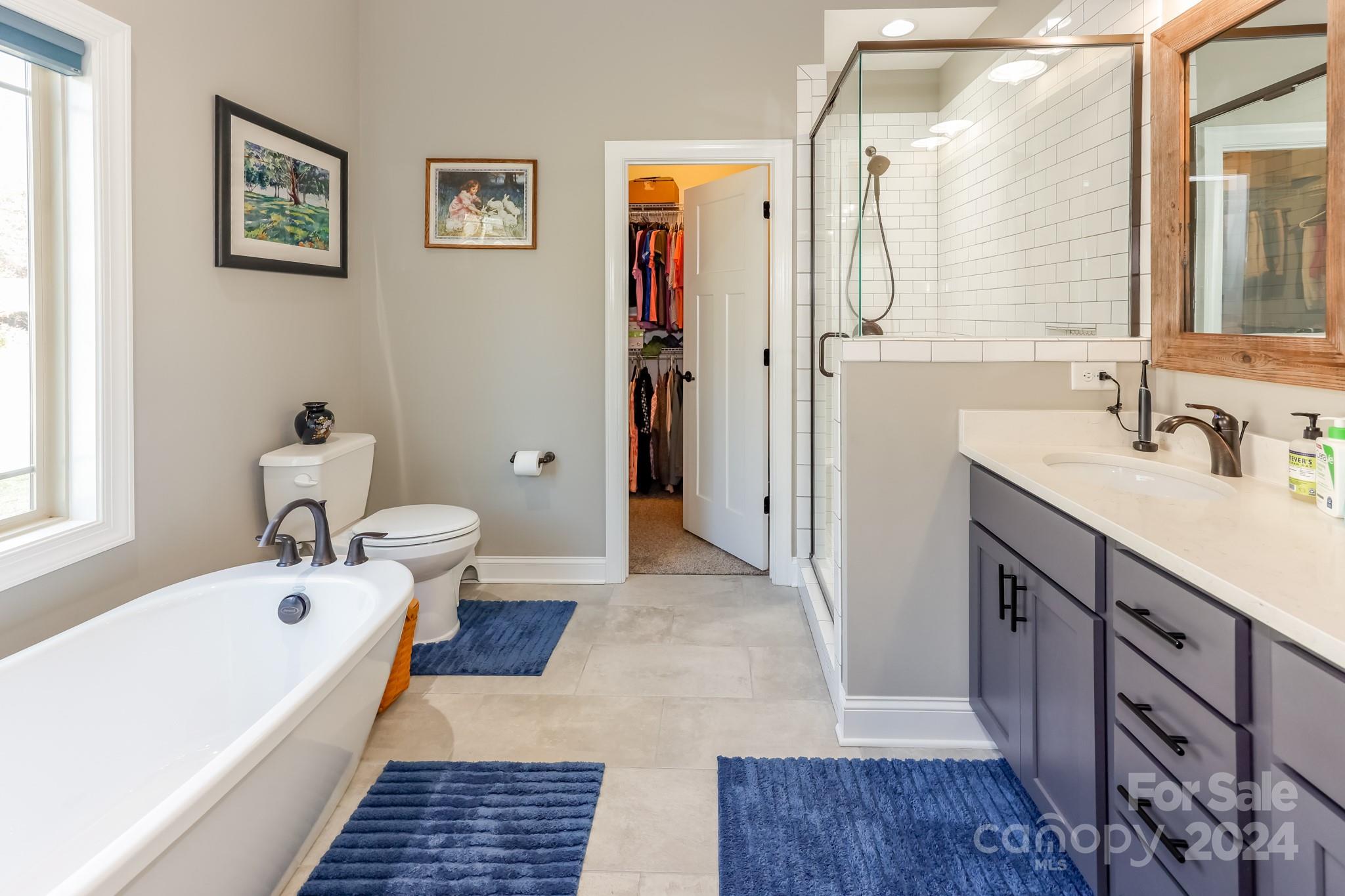 174 Spring Street Spindale, NC 28160 - Photo 13 of 30 a bathroom with a tub sink and mirror