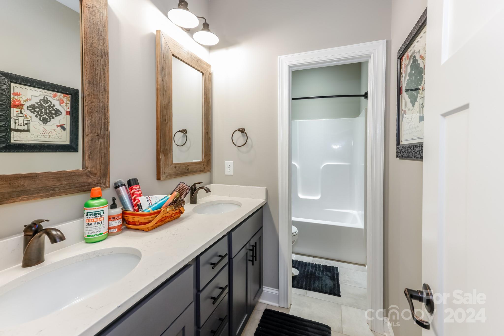 174 Spring Street Spindale, NC 28160 - Photo 15 of 30 a bathroom with a double vanity sink and a mirror