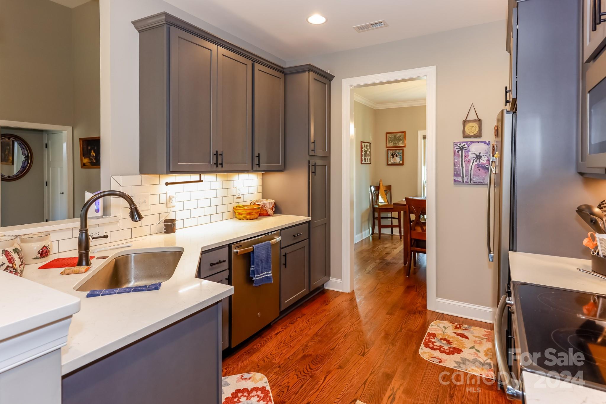 174 Spring Street Spindale, NC 28160 - Photo 8 of 30 a kitchen that has a lot of cabinets in it and wooden floor