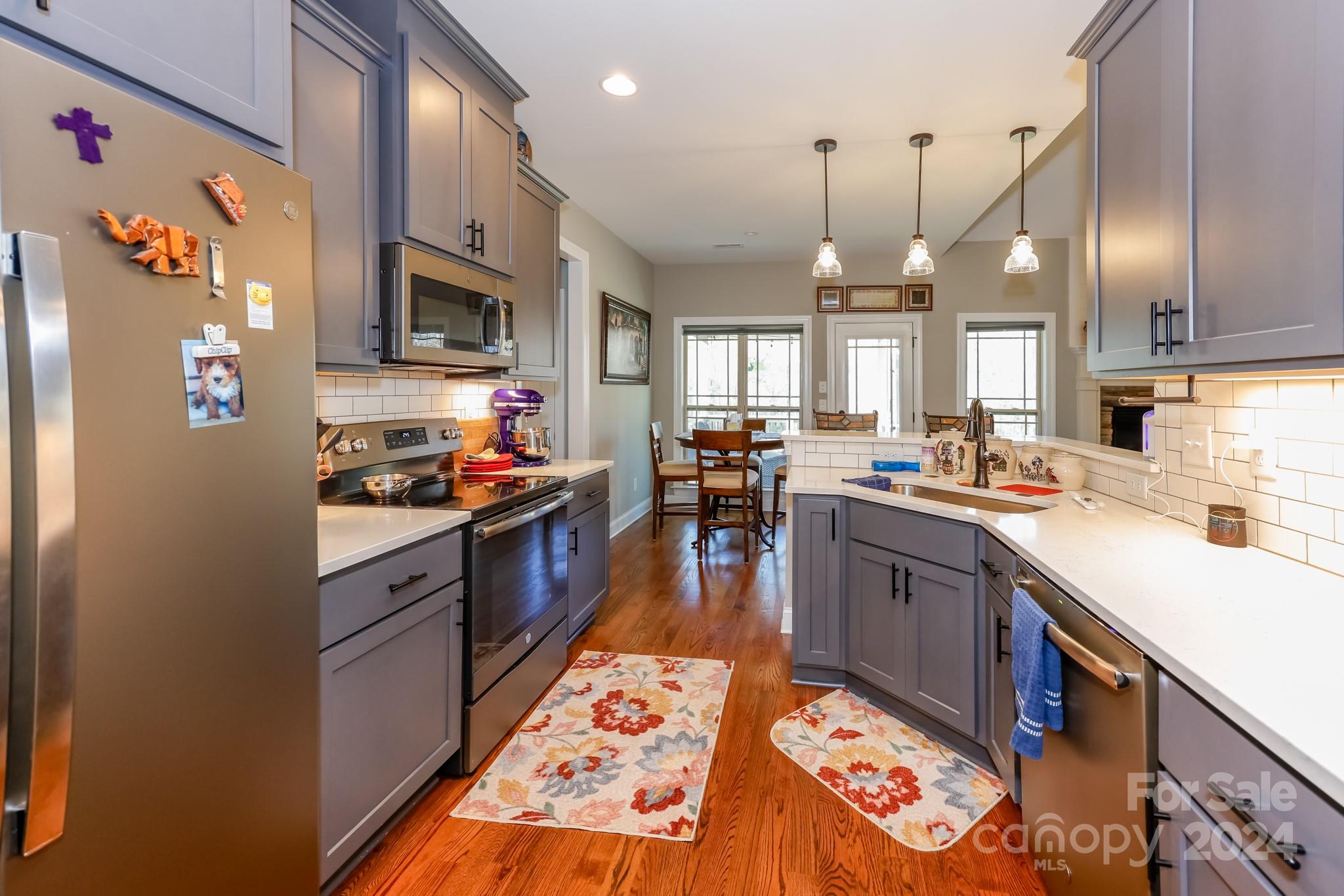 174 Spring Street Spindale, NC 28160 - Photo 9 of 30 a kitchen with stainless steel appliances kitchen island granite countertop a sink stove and refrigerator