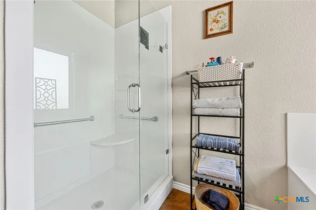 a bathroom with a shower and a sink