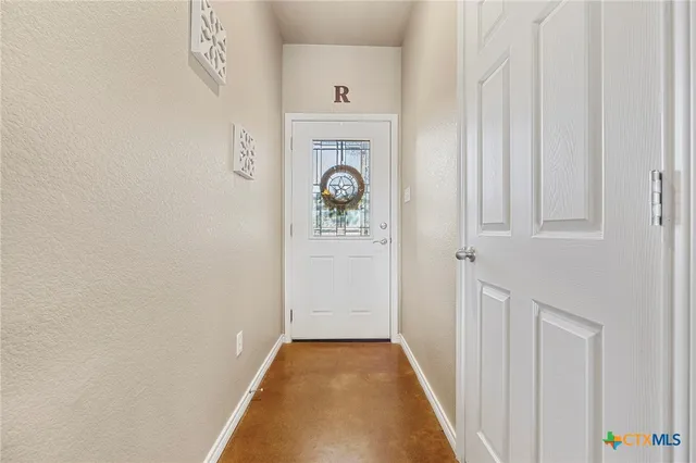 a view of an entryway with wooden floor